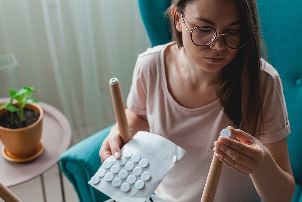 A girl choosing the felt pads that suites and match with furniture legs size