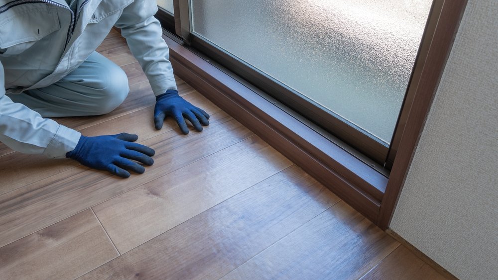 a professional inspecting-the-condition-of-hardwood-floor